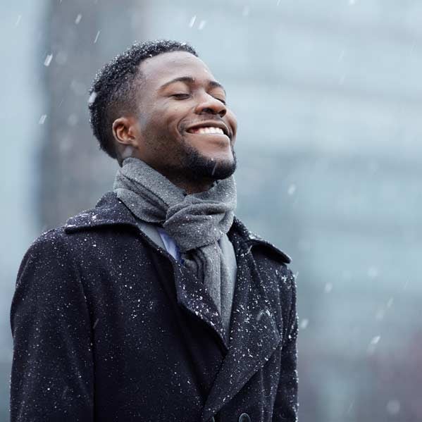 Happy-man-in-snowfall---canva_web