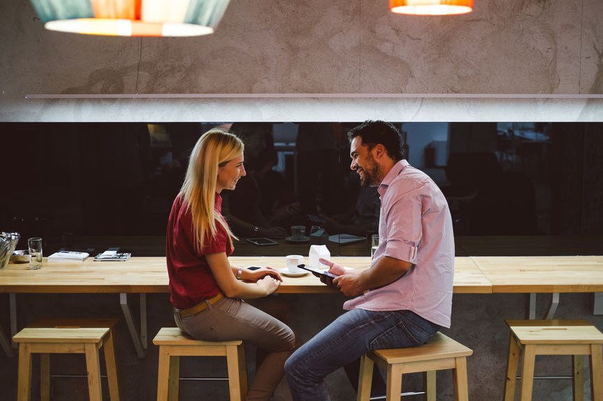 Two people talking at table