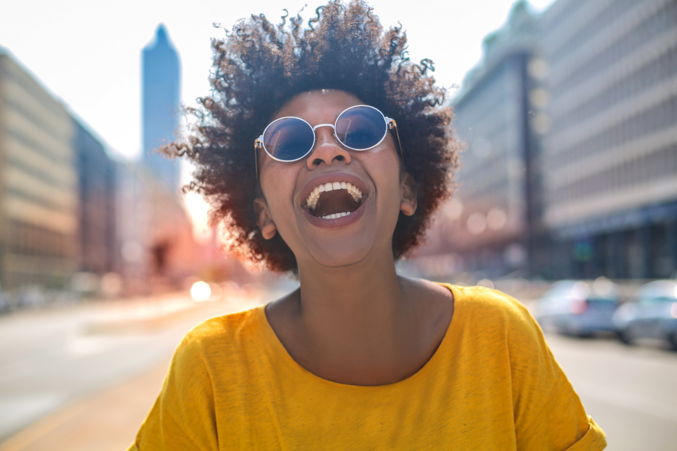 A Woman in Sunglasses Enjoying Life - A Brief Explanation of Energy Leadership Featured Image